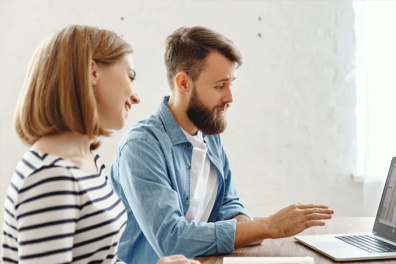 Young couple beginning an online therapy session with their practitioner via Zoom, highlighting accessibility and connection.